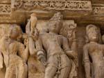 A bird perched on a Vishnu statue at the Vishwanath Temple