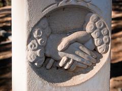 stone statue of hands shaking
