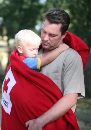 ES 127 man holding child cropped for OMR Hurricane Sandy: How to Help