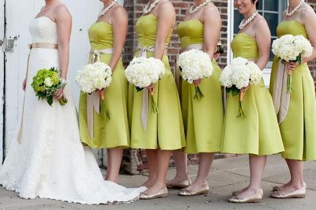 bridesmaids in short green dresses with white bouquets