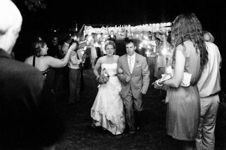 bride and groom leave wedding with sparklers