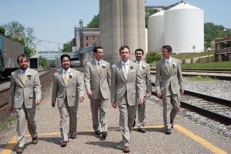 groom and groomsmen in gray suits on street