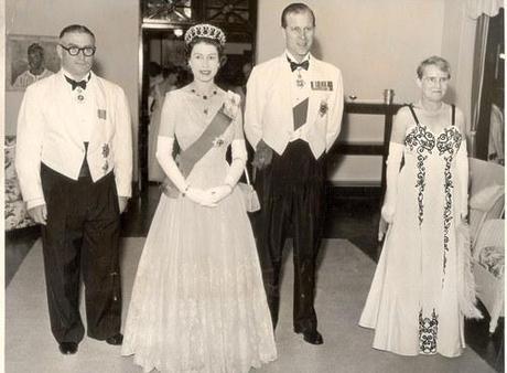 It’s Queen Elizabeth and Prince Philip’s 65th wedding anniversary today. To celebrate, I’m posting this picture of them next to a hilarious man wearing a dress.
Prince Philip: “For heaven’s sake, Roger, take off that white dress and stop acting like a homosexual!”
(I think I just crossed the line with that one. The person in the white dress is clearly a very nice lady. In the spirit of Prince Philip reputedly being a bigot, however, I will keep it.)
