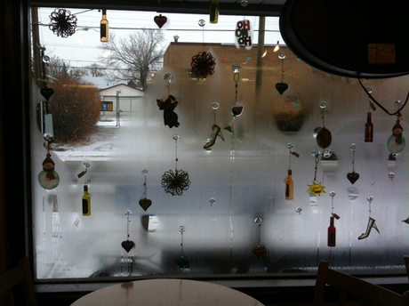 Silhouettes of heart-shaped Christmas ornaments in the window of Bell's Bookstore & Cafe, Calgary