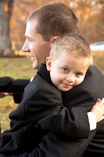 groom hugs young ring bearer