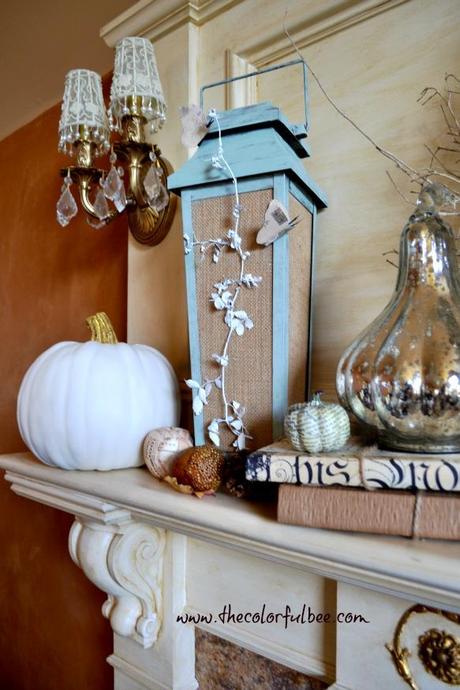a decorated fall mantle with painted pumpkins and 
