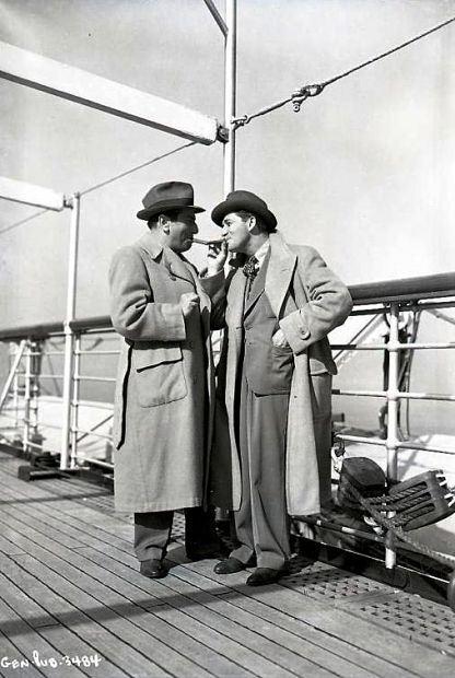 EL_Directors Ernst Lubitsch and Mervyn LeRoy compare the size of their cigars