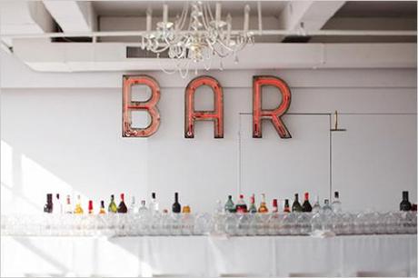A Well-Stocked Wedding Bar Love me a neon BAR sign. Image via Alexan Events