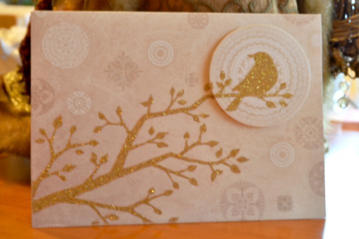 Christmas card with gold glittered bird in a tree