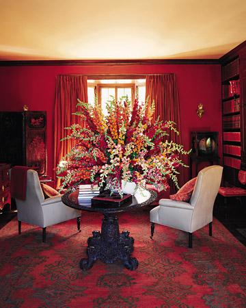 red dining room with Chinese screen, light being dining chairs, faux bois panelling, Martha Stewart