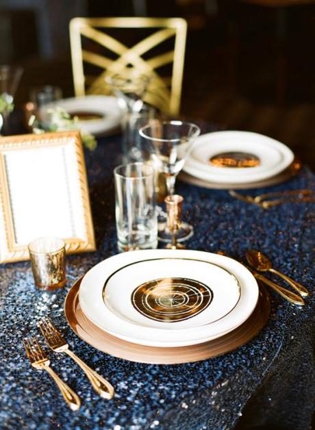 Gold place settings on navy sequinned linen, people! Glorious, magical image via Sceme Events