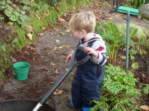 young boy helps with gardening