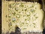 Peeling floral painting on a wooden door