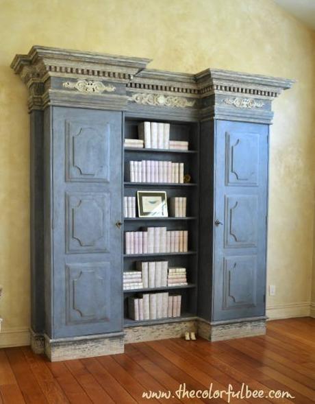 a blue gray Tara Shaw bookcase in a beautiful room