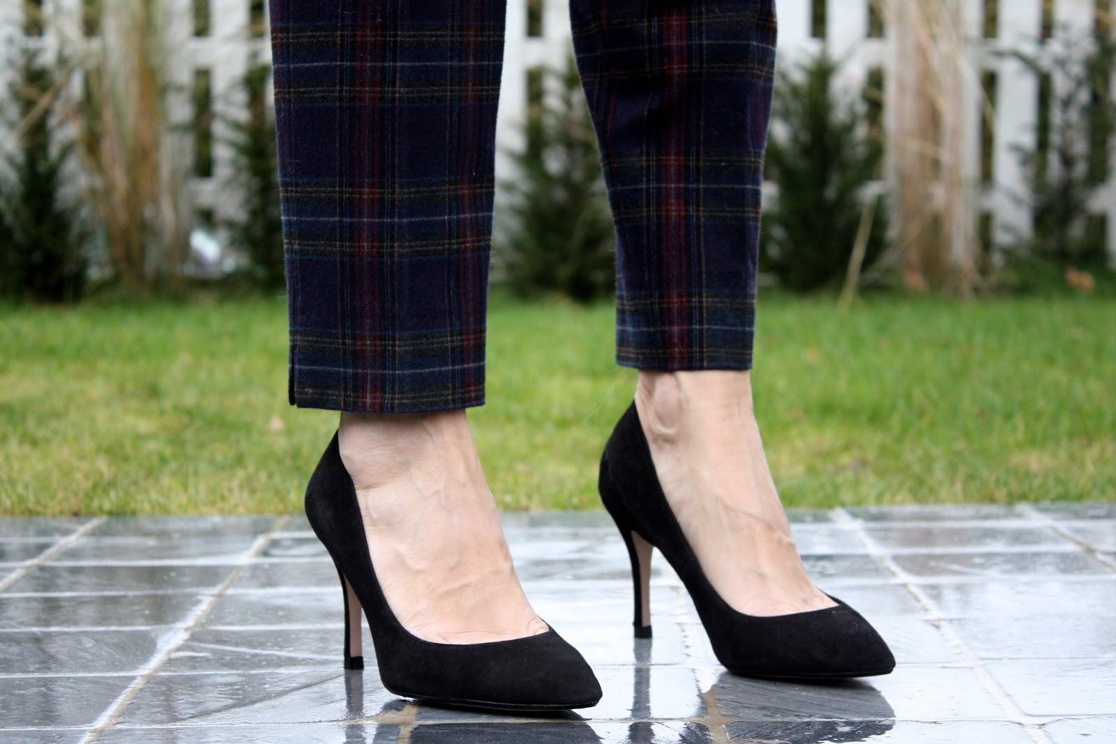 The plaid trousers and the black suede pumps