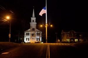 A flag flies at half-staff on Main Street in Newtown, Conn., on Dec. 15 2012 (David Goldman/AP)