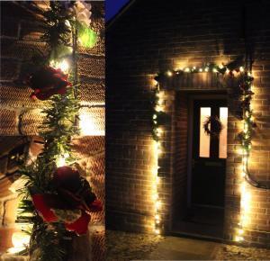 christmas lights around porch with rose garland