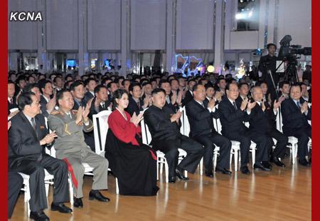 Kim Jong Un (4th L) and his wife Ri Sol Ju (3rd L) applaud during a performance by the Moranbong Band at a banquet celebrating the 12 December 2012 launch of the U'nha-3 rocket.  Also in this image are: Jang Song Taek (L), Choe Ryong Hae (2nd L), Choe Chun Sik (4th R), Kim Yong Nam (3rd R), Choe Yong Rim (2nd R) and Pak To Chun (R) (Photo: KCNA)
