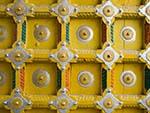 Brightly yellow painted entrance door of a Hindu temple