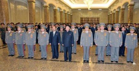 Kim Jong Un (6th L) pays his respects in front of statues of his grandfather Kim Il Sung and his father Kim Jong Il, during a visit to the Ku'msusan Memorial Palace in Pyongyang on 24 December 2012.  In attendance in the front row are: Kim Won Hong (L), Pak To Chun (2nd L), Kim Yong Chun (3rd L) Choe Ryong Hae (4th L), Choe Chun Sik (5th L), Jang Song Taek (4th R), Hyon Yong Chol (3rd R) Kim Kyok Sik (2nd R) and Hyon Chol Hae.  Visibile in the second row are: Kim Kyong Ok (5th L) and Yun Jong Rin (3rd R) (Photo: Rodong Sinmun)