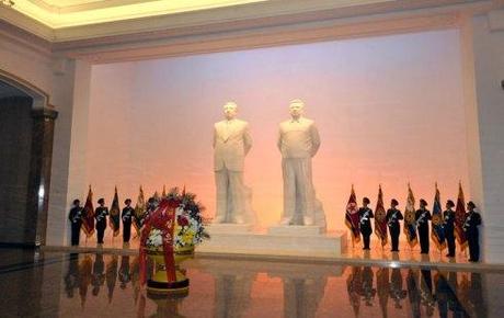 A floral basket from Kim Jong Un sits in front of statues of Kim Il Sung and Kim Jong Il at the Ku'msusan Memorial Palace.  KJU visited Ku'msusan, where the preserved remains of his father and grandfather lie in state, on at midnight on 24 December 2012 in commemoration of the 21st anniversary of Kim Jong Il's assumption of office as KPA Supreme Commander on 24 December 1991.  24 December is also the birthday of Kim Jong Suk, mother of Kim Jong Il (1941-2011) and his sister Kim Kyong Hui (1946--) (Photo: Rodong Sinmun)