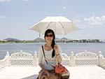 Sonya resting on a white stone chair