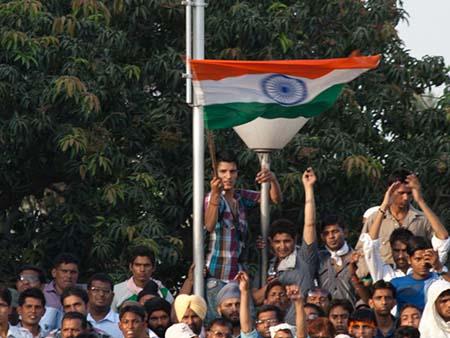 Patriotic Indian boy waving a large Indian flag