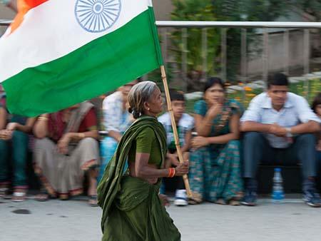 Elderly Indian women running with an Indian flag