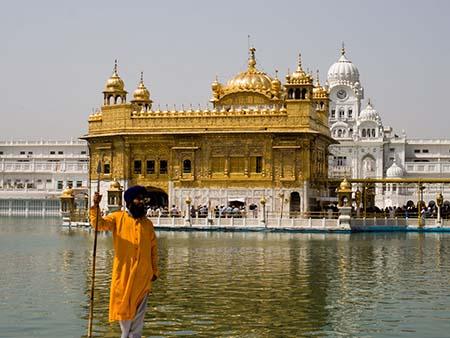 Sikh man wearing traditional Orange and Blue colours that reflect the Khalsa