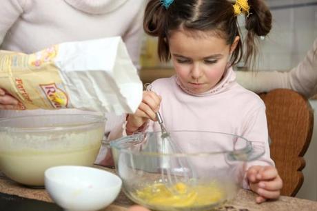 Young girl learning how to cook