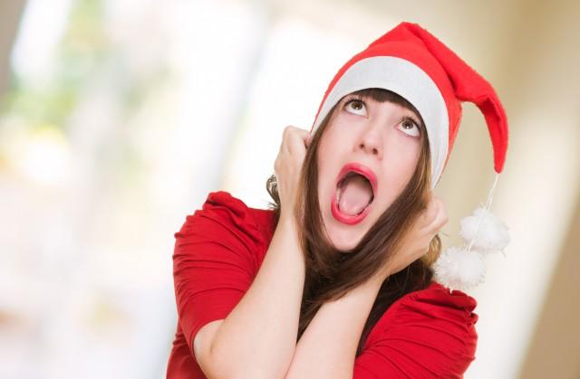 stressed woman wearing a christmas hat