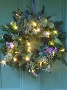 pine wreath with lights and clematis flowers