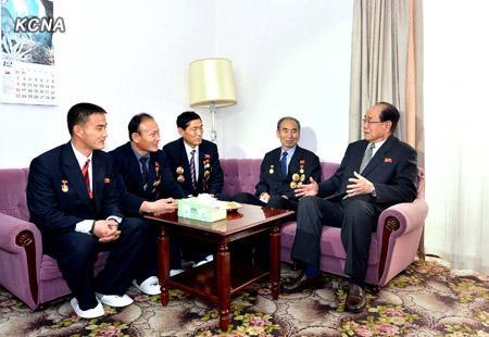 Kim Yong Nam (R) talkes with scientists, technicians and other personnel involved in the 12 December 2012 U'nha-3 rocket launch.  Kim was visiting the Pyongyang hotel where the launch personnel are staying.  (Photo: KCNA)