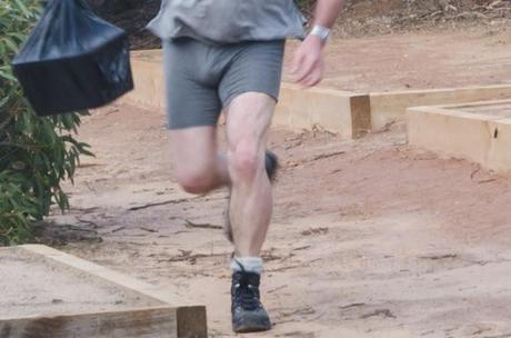 man running with underpants and boots on