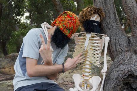 skeleton and man with beard imitating gangsters