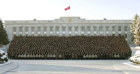 Kim Jong Un (seated, 1st row, 19th L) poses for a commemorative photograph with personnel who contributed to the 12 December 2012 launch of the U'nha-3 rocket and Kwangmyo'ngso'ng-3 satellite in front of the KWP Central Committee #1 Office Building in central Pyongyang (Photo: Rodong Sinmun)