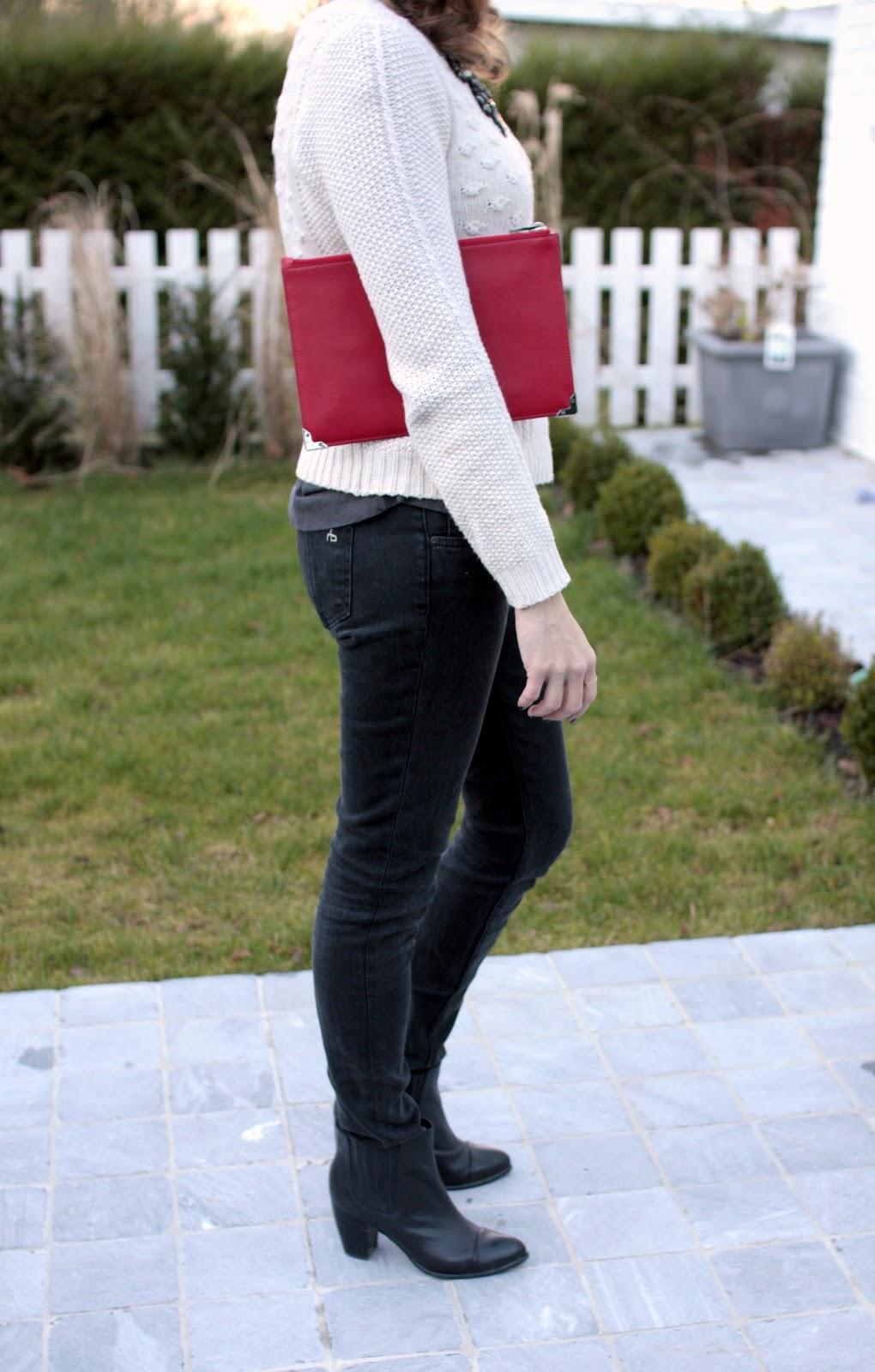 The dark grey jeans and the bright red clutch