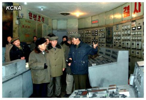 Choe Yong Rim (L) is briefed about the Pukch'ang Thermal Power Complex in South P'yo'ngan Province (Photo: KCNA)