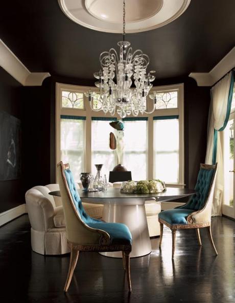 black dining room with large white moldings and blue accents