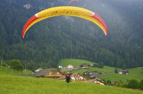 The paragliding landing in Alpe di Siusi (Seiser Alm), Italy