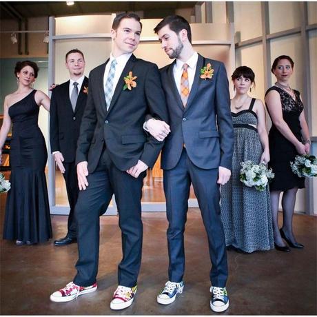two grooms pose at wedding