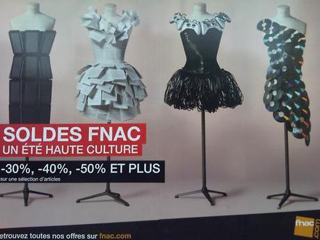 MEDIA DRESSES
Ive been walking past this poster for days now, thinking I must take a photo for my blog. This advertisment for the FNAC summer sale is pretty cool in my book. It depicts technology and media as fashion items which - after spending almost a months salary on new laptop this afternoon & given that i took the photo with my Blackberry - i would definitely agree with. 
My personal favorite is the middle right one. The cable makes a pretty good tutu and i like the way that the consols flatter the bust shape. The paper dress also works because it looks like you could actually wear it. Im not so keen on the Disks one because it reminds me of the Paco Rabanne chain-mail dress which ive never really liked & the left one doesnt seam to be wearable, though the use of tactile screens (ipones or ipads or something) says “touch me” which is kinda cool.
Technology worn as fashion is nothing unusual these days - as Lady Gaga, for example, has proved on many an occasion, so its quite smart and hip for the Book/music store market themselves this way.
FNAC is like the French version of Virgin Magastores or HMV.