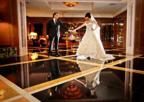 groom and bride pose in ballroom