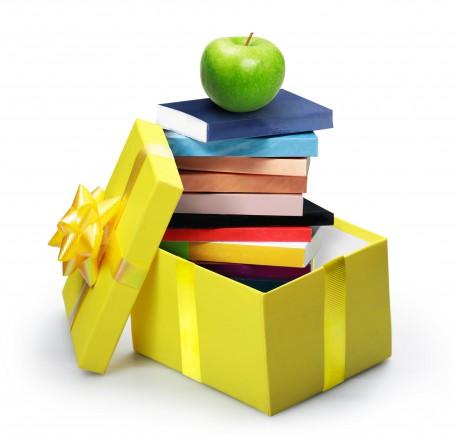 Open yellow gift box, stack of books