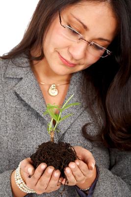 business woman planting a tree