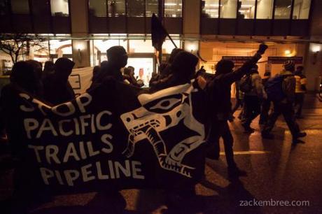 Militants carry banner against Pacific Trails Pipeline during anti-Enbridge rally, Jan 14, 2013.