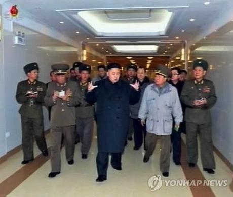 Kim Jong Un (3rd L) talks to Gen. Choe Ryong Hae (2nd R) during a tour of the construction of Taesongsan General Hospital (Photo: KCNA-Yonhap)
