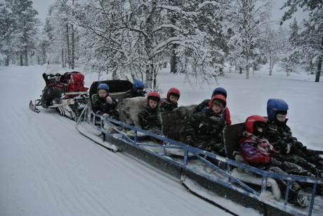 The children rode in a sleigh behind the Snowmobile leader.