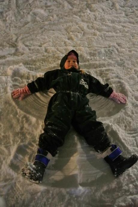 My Daughter making a Snow Angel for Santa outside his Log Cabin