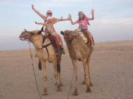 My daughter and I, and another child from our tour group riding camels